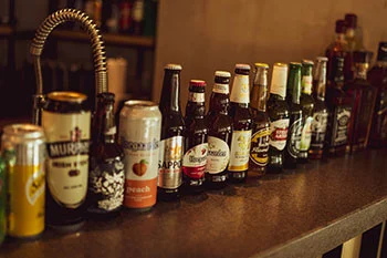A row of beer bottles on a condominium counter.