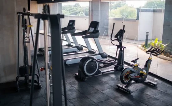 Hotel gym equipment in a room with a view.